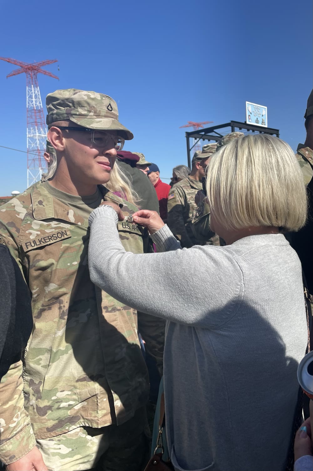 Wyatt's mom pinning his Airborne wings at graduation